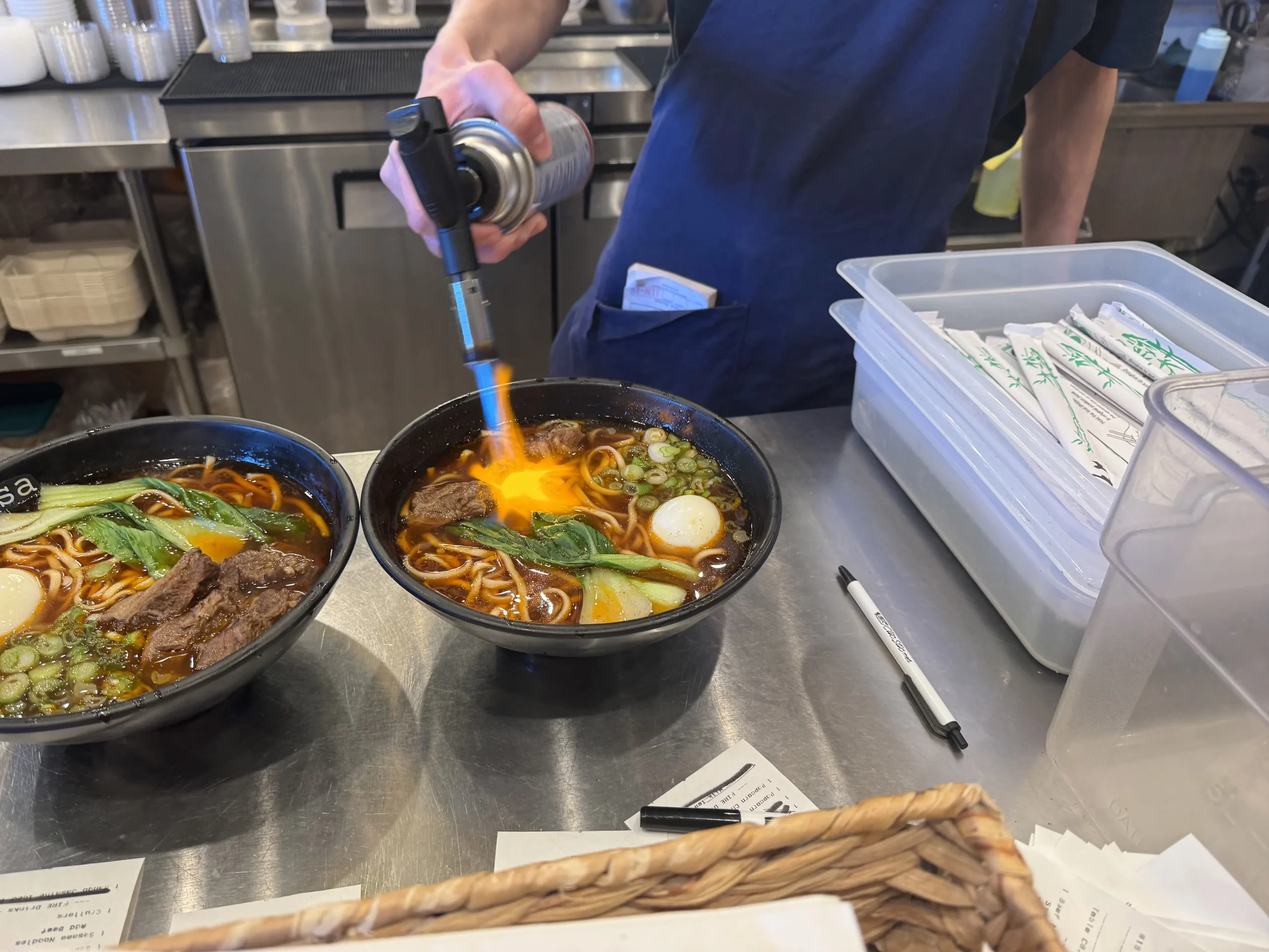 server blowtorching the beef on my beef noodle soup